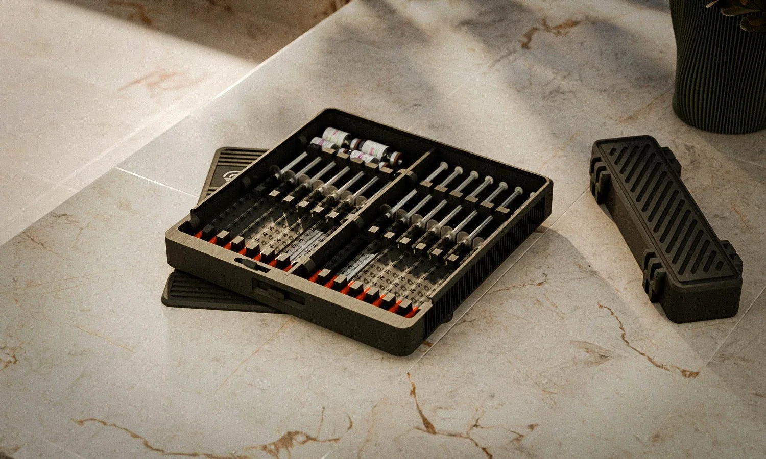 Routine Box open on a sunlit marble counter beside its travel case