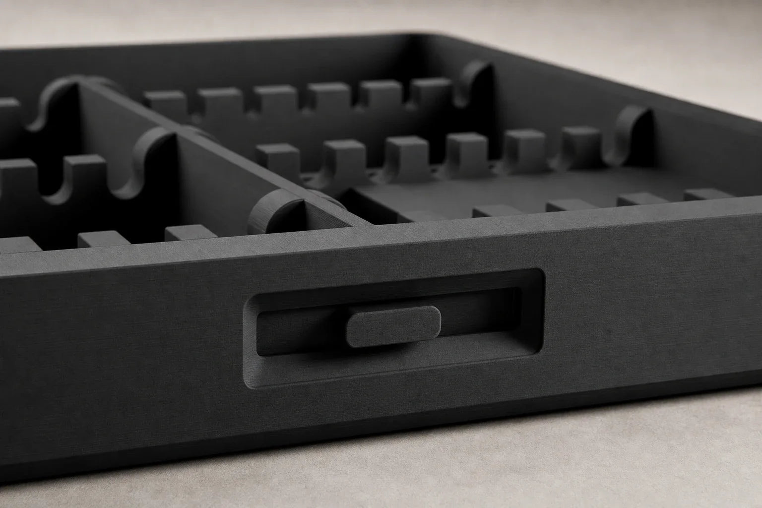 Macro detail of the Routine Box tray, dividers, and front latch
